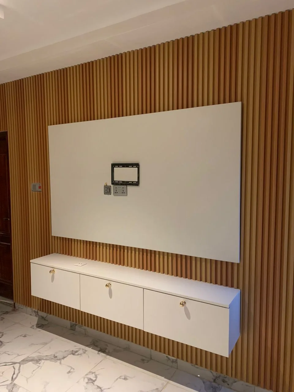 Slat wall with floating TV cabinet
