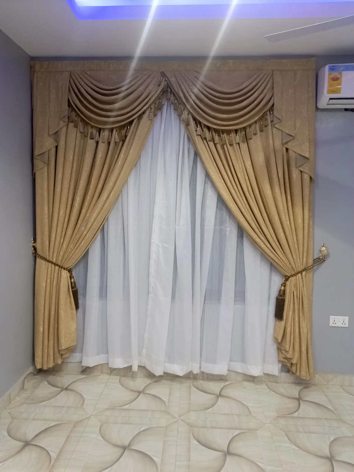 Swag and tail curtains with tasselled valance