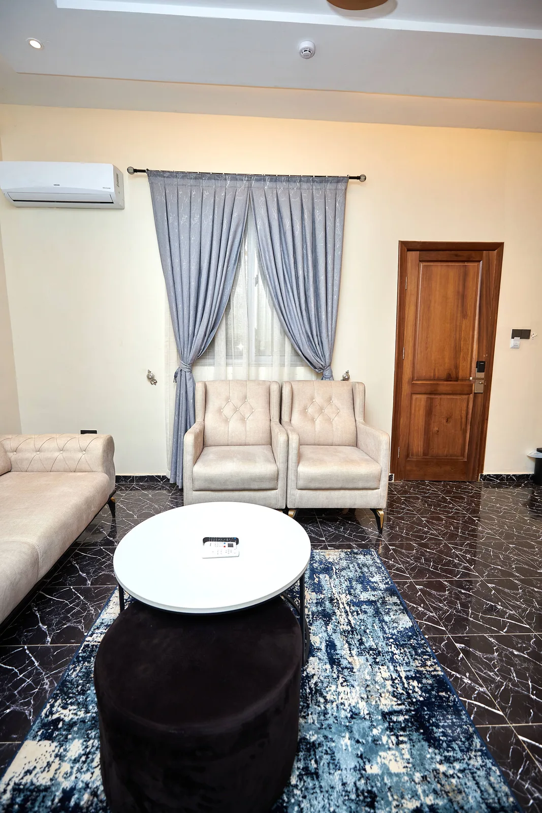 Sitting room, grey curtains and tufted chairs