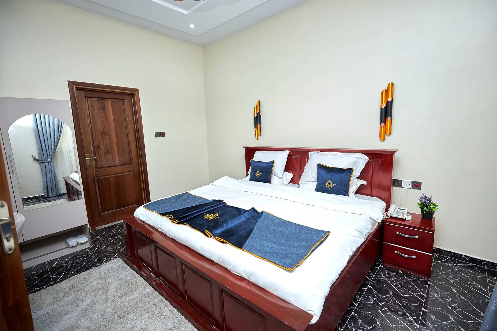 Bedroom with sun mirrors and wall sconces