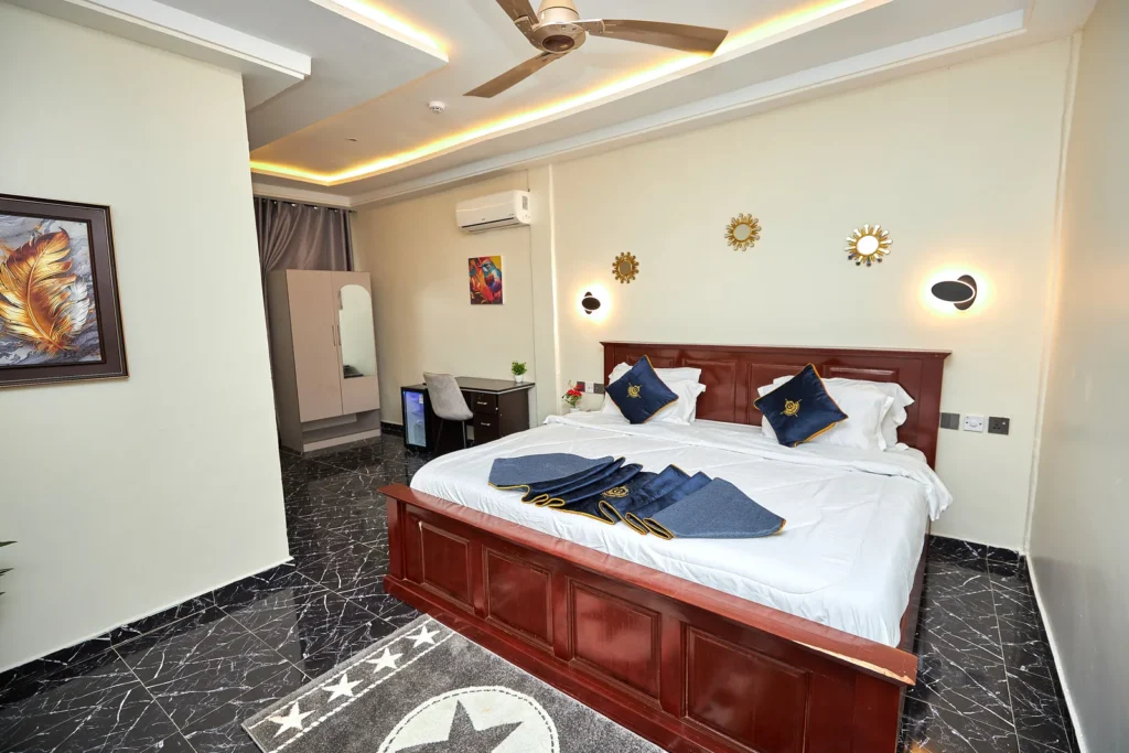 Hotel bedroom with navy and gold bedding
