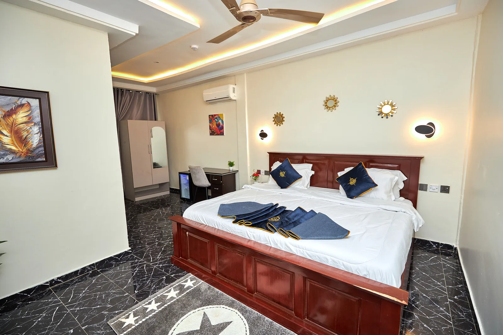 Hotel bedroom with navy and gold bedding
