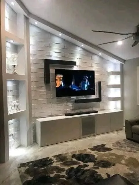 Lit stone-effect TV wall with niches