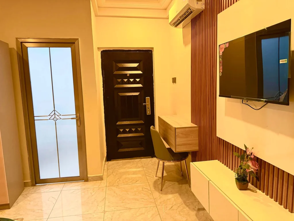 Best Interior Designers in Kumasi, Entry with floating desk and slat wall