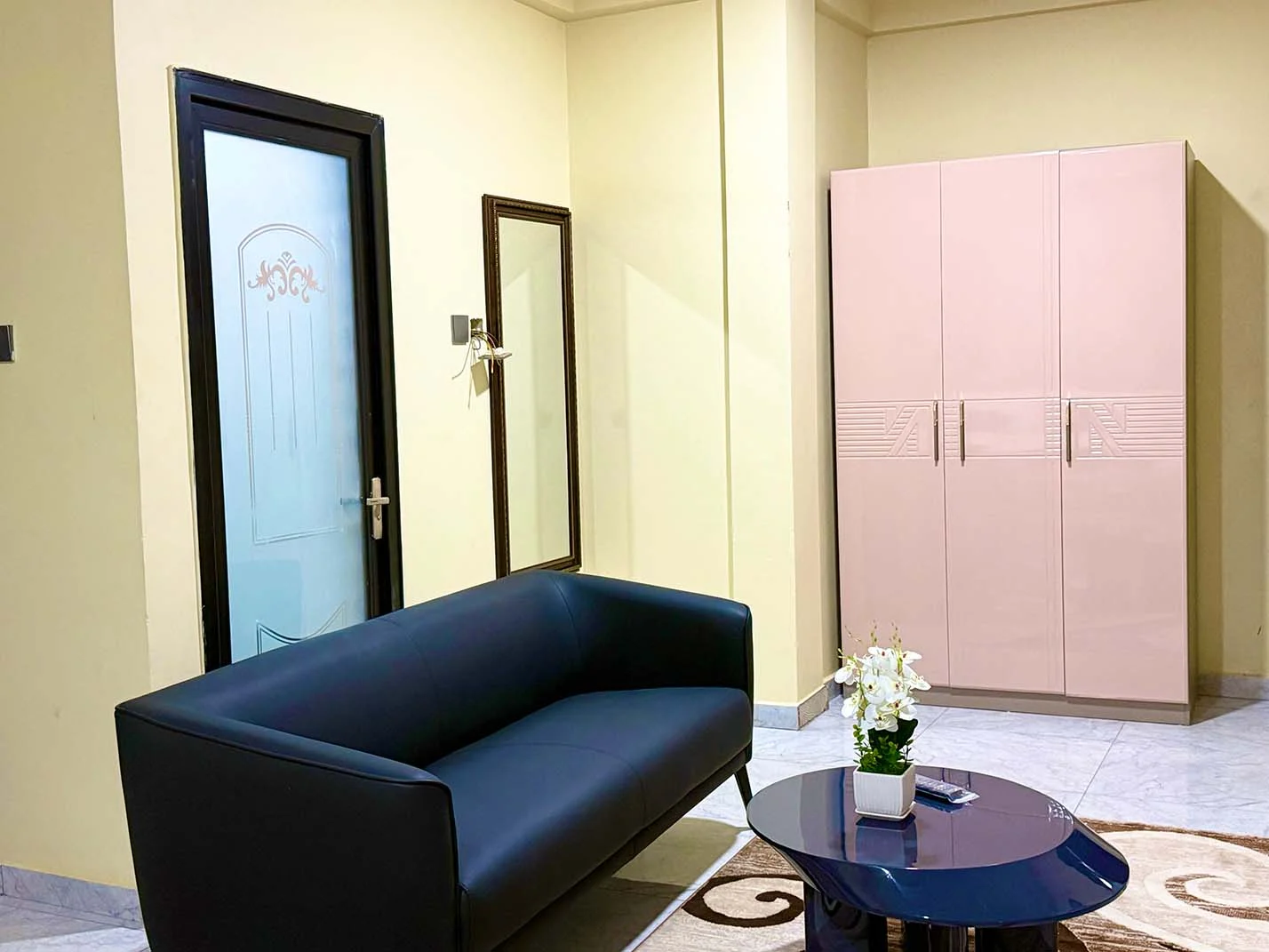 Best Interior Designers in Kumasi, Suite sitting area with navy sofa