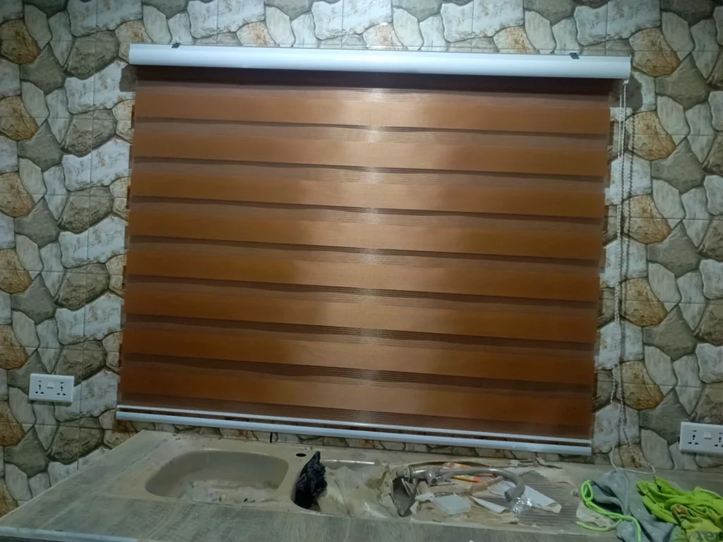 Best Interior Designers in Kumasi, Zebra blind over a stone-tiled kitchen wall
